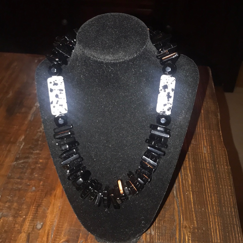 Black necklace with white stones.